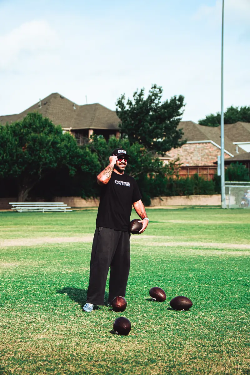 Craig LeBlanc on a football field with footballs, 2 Live Craig media kit