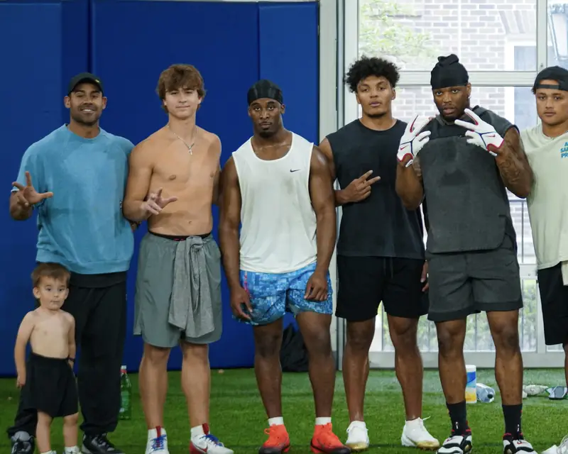 Craig LeBlanc and Dawsy with 2 Live Culture athletes at a group football training session in DFW